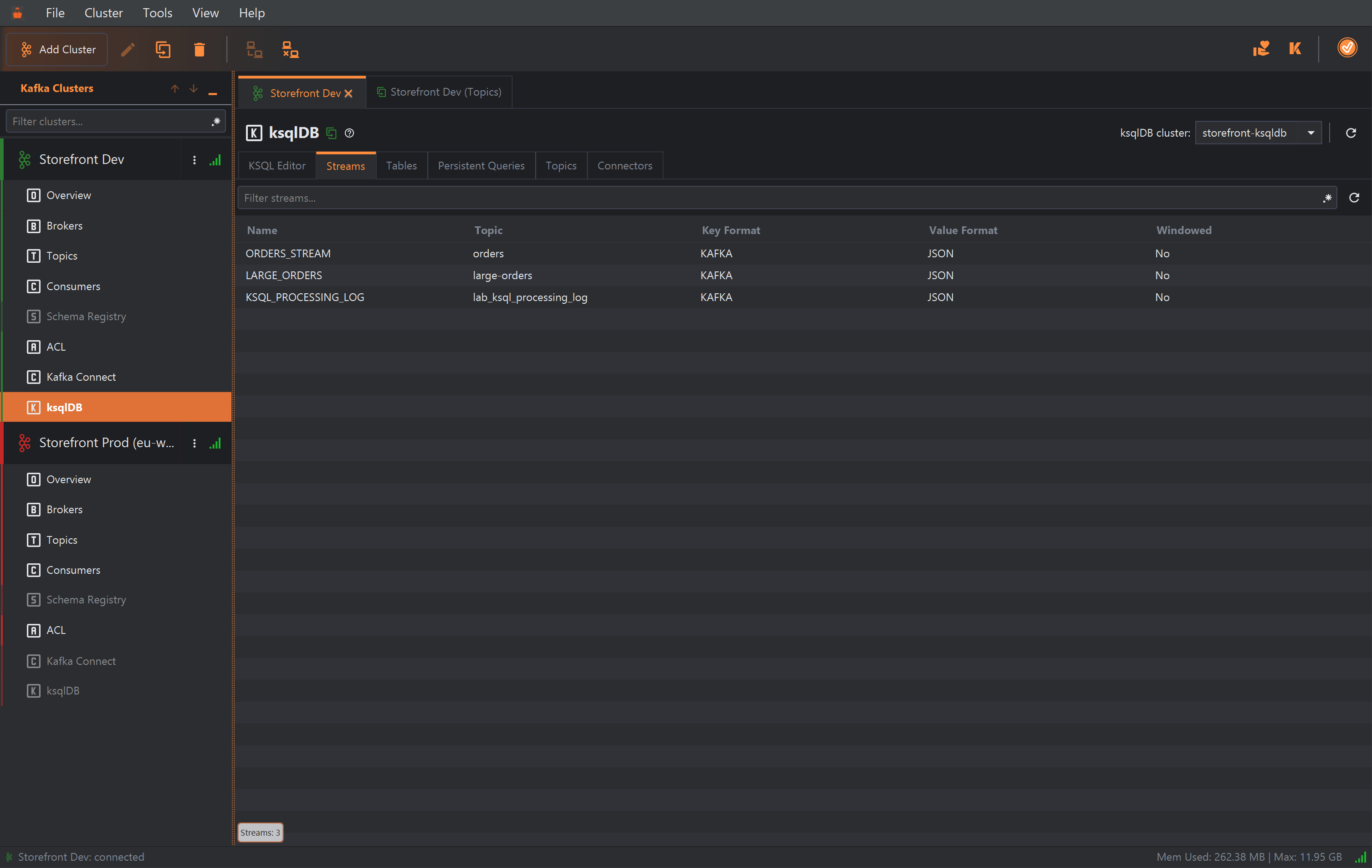 The Streams tab with a Filter streams... box and a refresh button, listing three streams with Name, Topic, Key Format, Value Format and Windowed: ORDERS_STREAM on orders, LARGE_ORDERS on large-orders and KSQL_PROCESSING_LOG on lab_ksql_processing_log, all KAFKA keys, JSON values and not windowed.