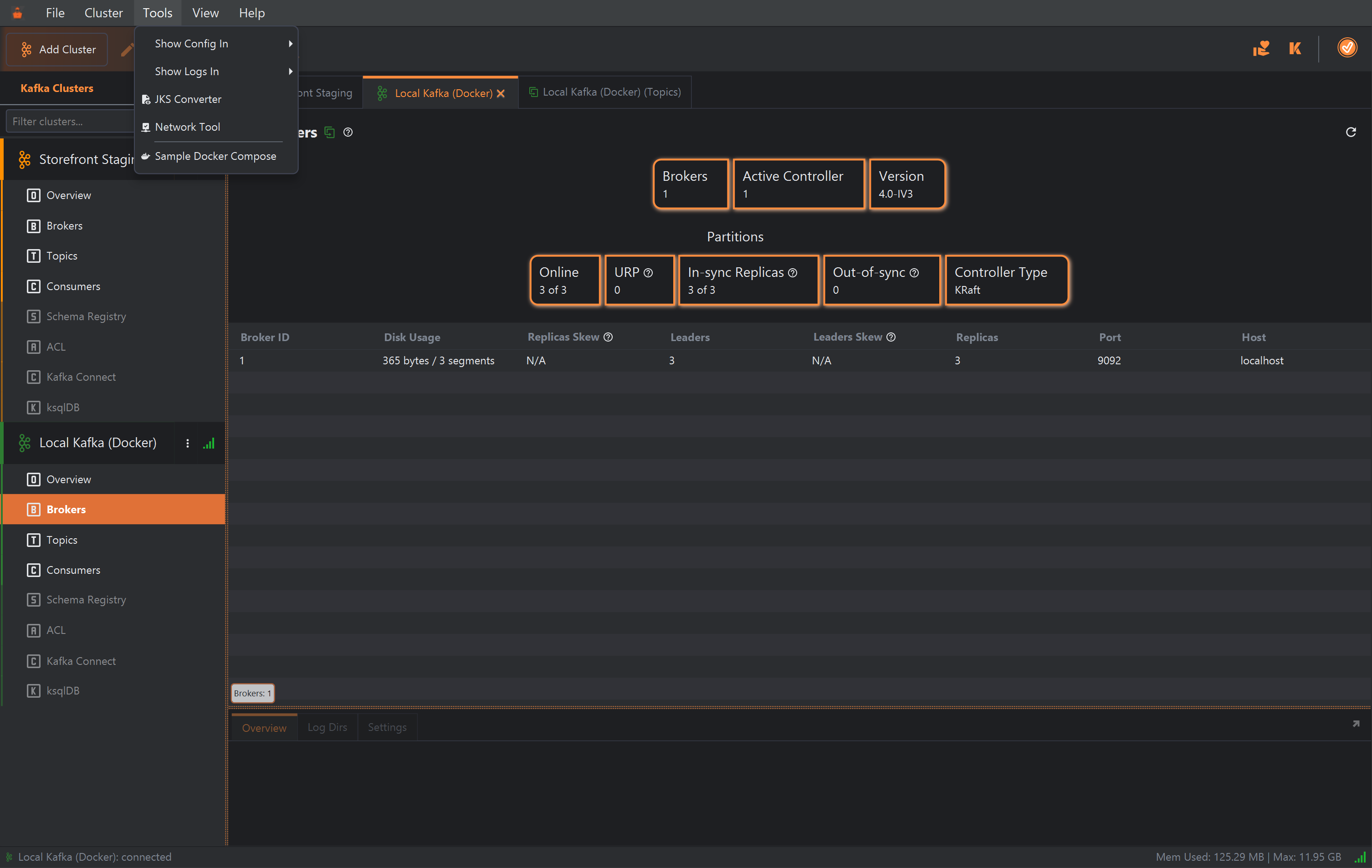 KafkIO's main window with the Tools menu open. It lists Show Config In, Show Logs In, JKS Converter, Network Tool and Sample Docker Compose; Sample Docker Compose is highlighted. Behind it, Storefront Staging and Local Kafka (Docker) are connected, and a duplicated Local Kafka (Docker) (Topics) tab is open beside the main Local Kafka (Docker) tab.